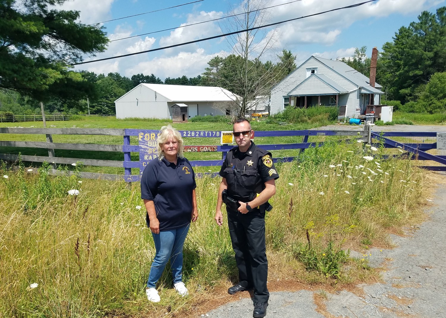 Joanne Gerow of C.A.R.E (left) and Sheriff’s Sergeant Blake Starner at the farm on Route 17B in Bethel.