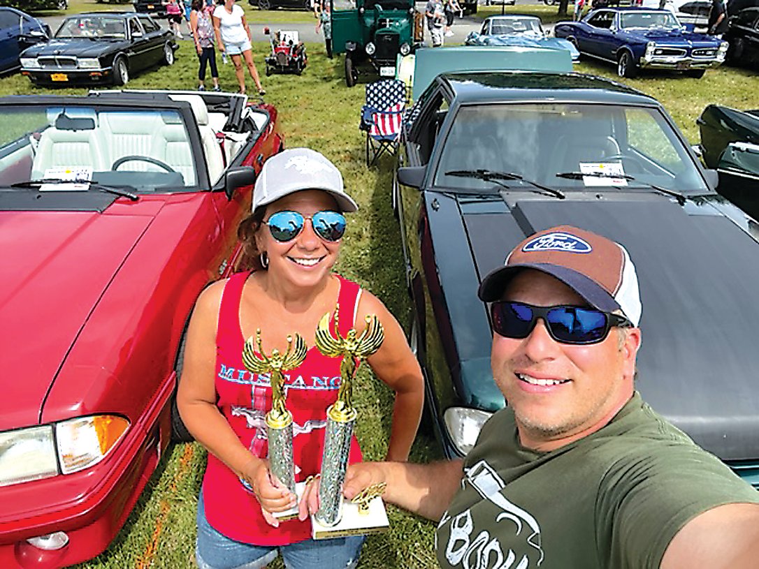 Barbara and James Matos received a trophy for finishing in the Top 40. They each brought a Ford Mustang.