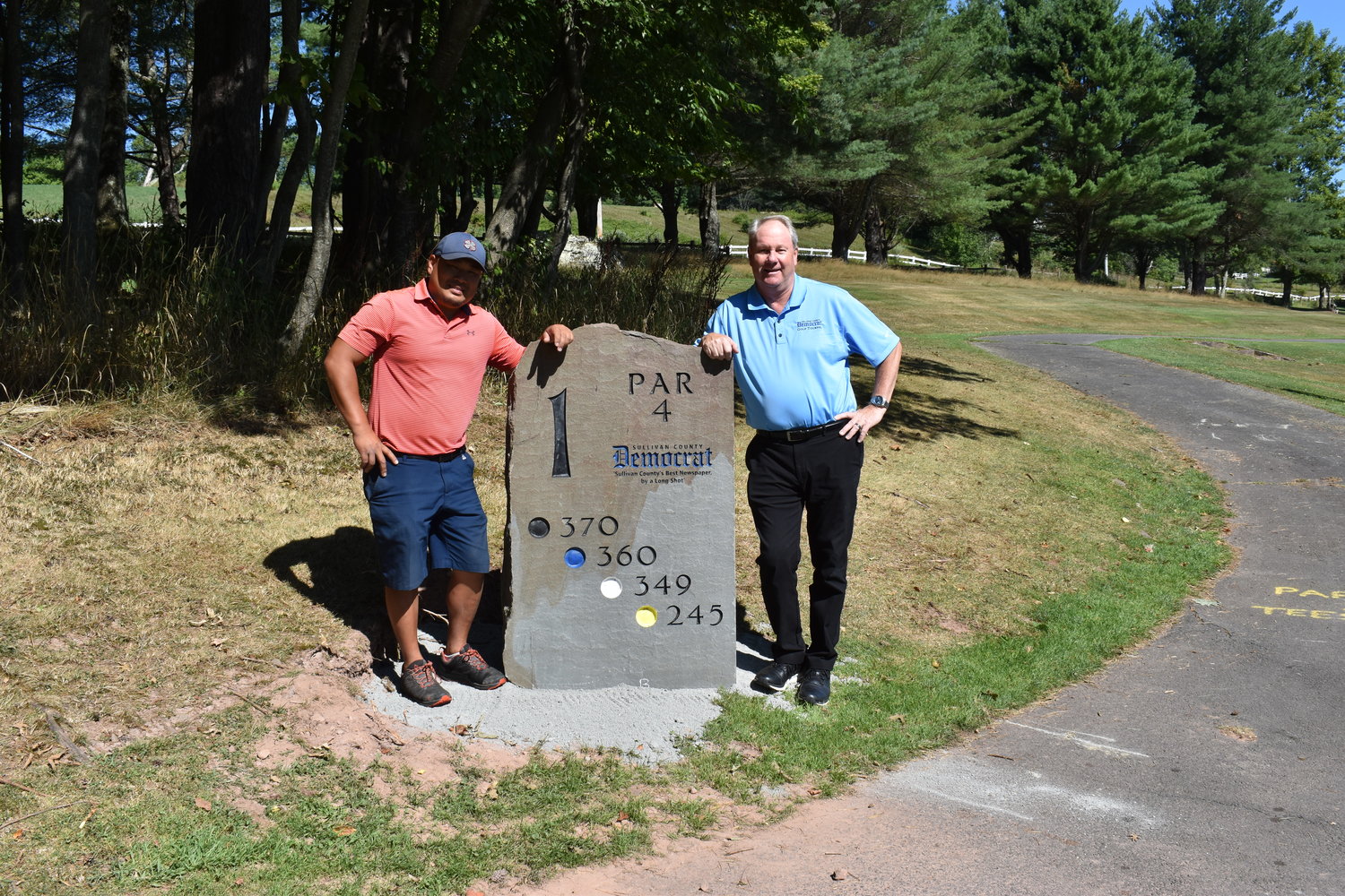 Golf Course Superintendent Will O’Brien (left) and Democrat Publisher Fred Stabbert III show off the new tee marker, sponsored by the Democrat, on hole one.