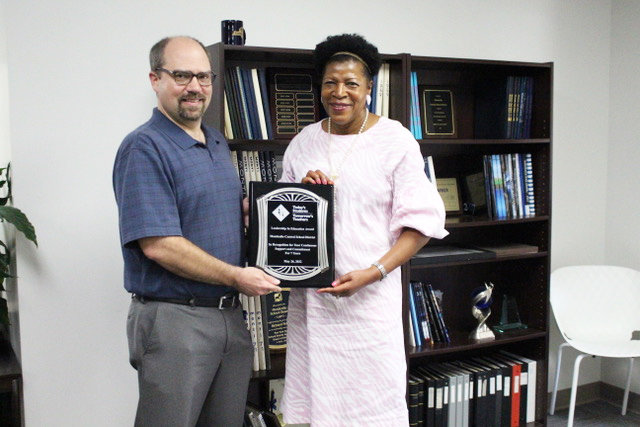 TSTT CEO Dr. Bettye Perkins presented a “leadership in education” award to Superintendent of Schools Dr. Mat-thew Evans