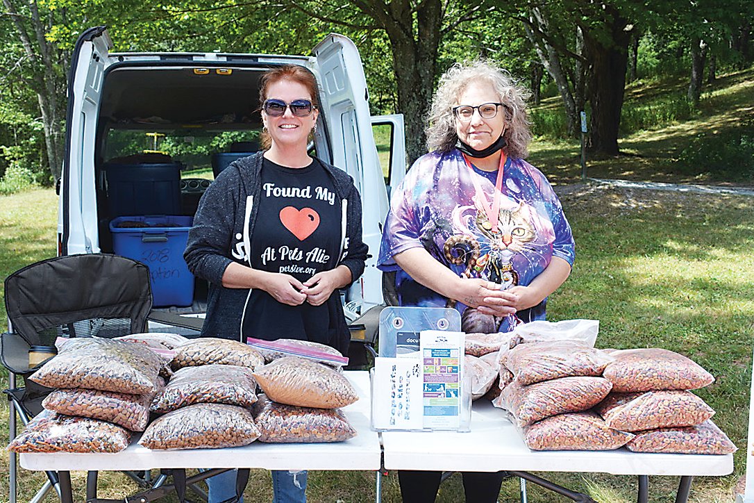 Pets Alive Executive Director Becky Tegze (at left) and volunteer Susan Sackett handed out free dog and cat food.