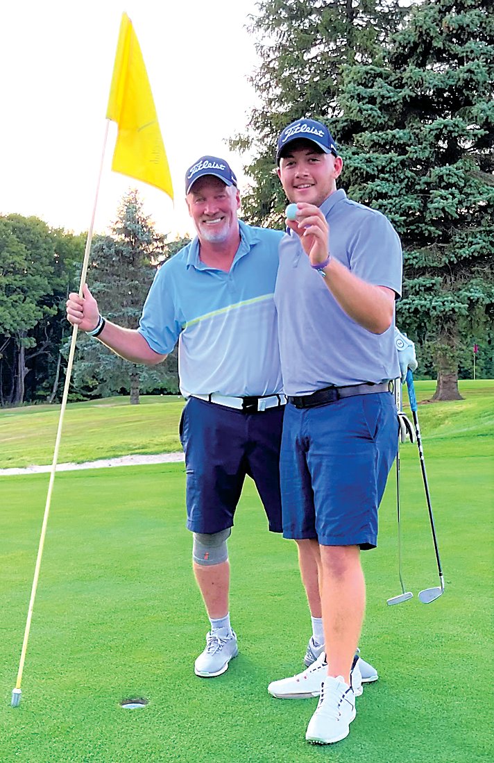 Roscoe’s Collin Tallman, right, is all smiles after retrieving his albatross golf ball from the cup on the 302-yard, par-4 eighth hole at the Tennanah Lake Golf Course. Tallman’s league partner Tom Roseo smiles while holding the 8th hole flag stick. Tallman and Roseo are this year’s first place league champions.