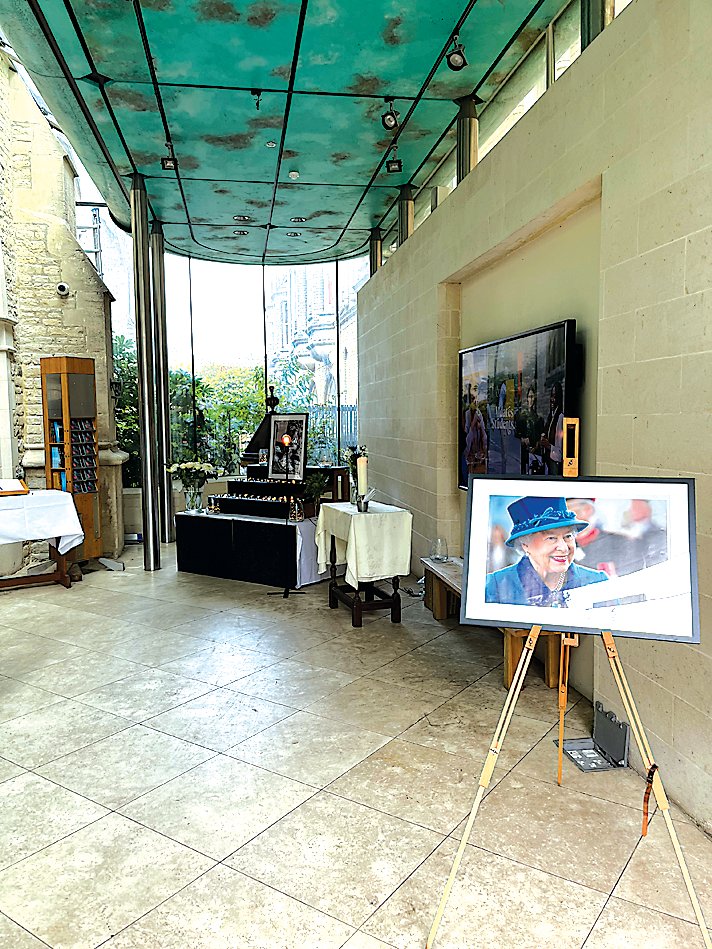 Shrines adorned with photographs commemorate the recent passing of Queen Elizabeth II.