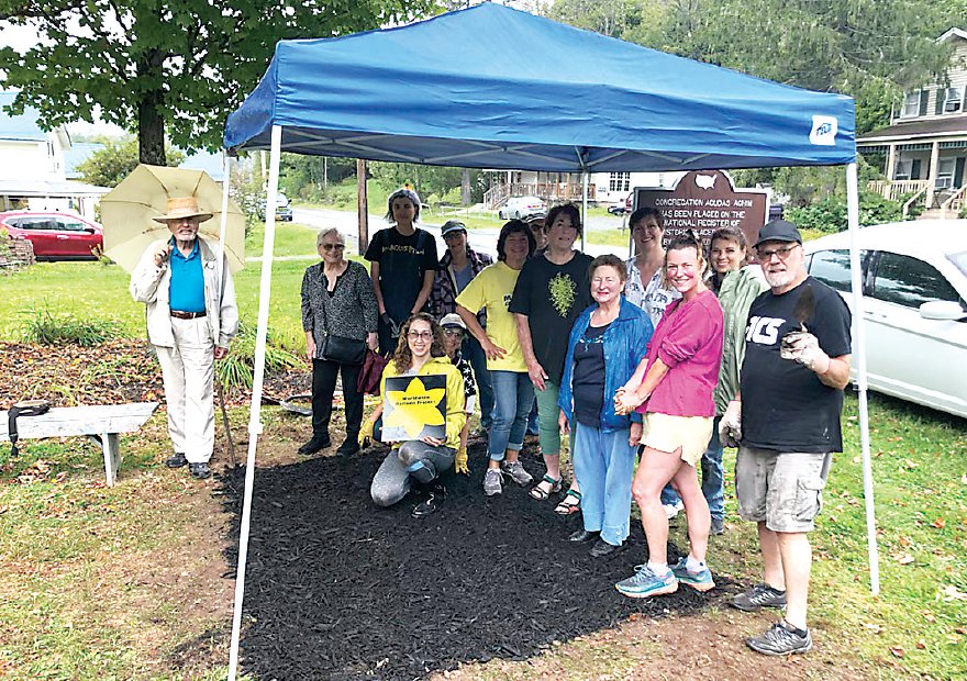 Community members participated in the planting of 250 Narcissus Dutch Master daffodils from Holland during a few rain showers on September 11.