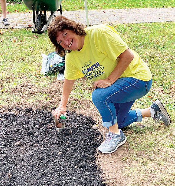 Judy Siegel, president of Congregation Agudas Achim (CAA) in Livingston Manor, participating in the planting.