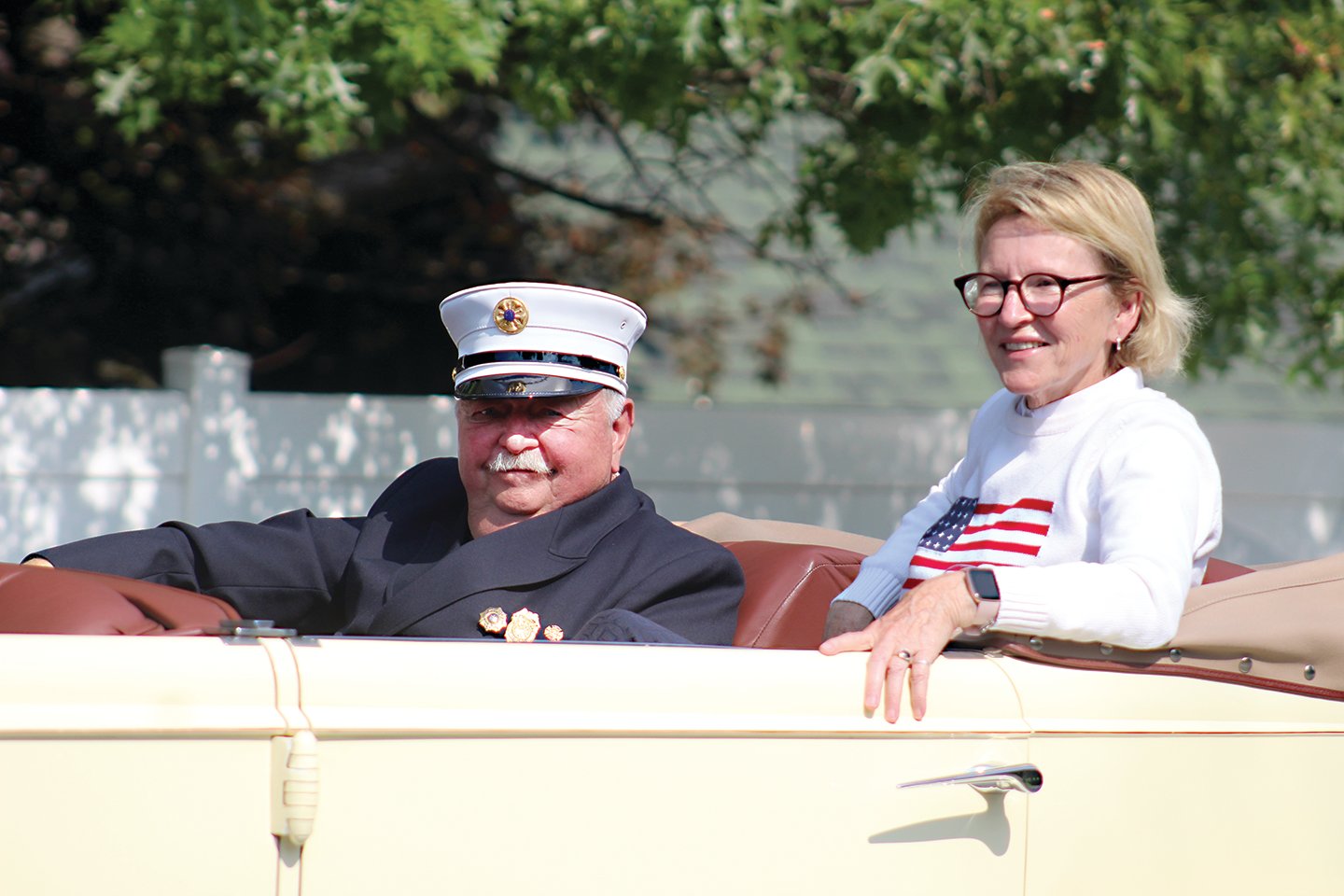 Second Division Grand Marshal, Past Chief Robert Keesler, rides alongside Assemblywoman Aileen Gunther.