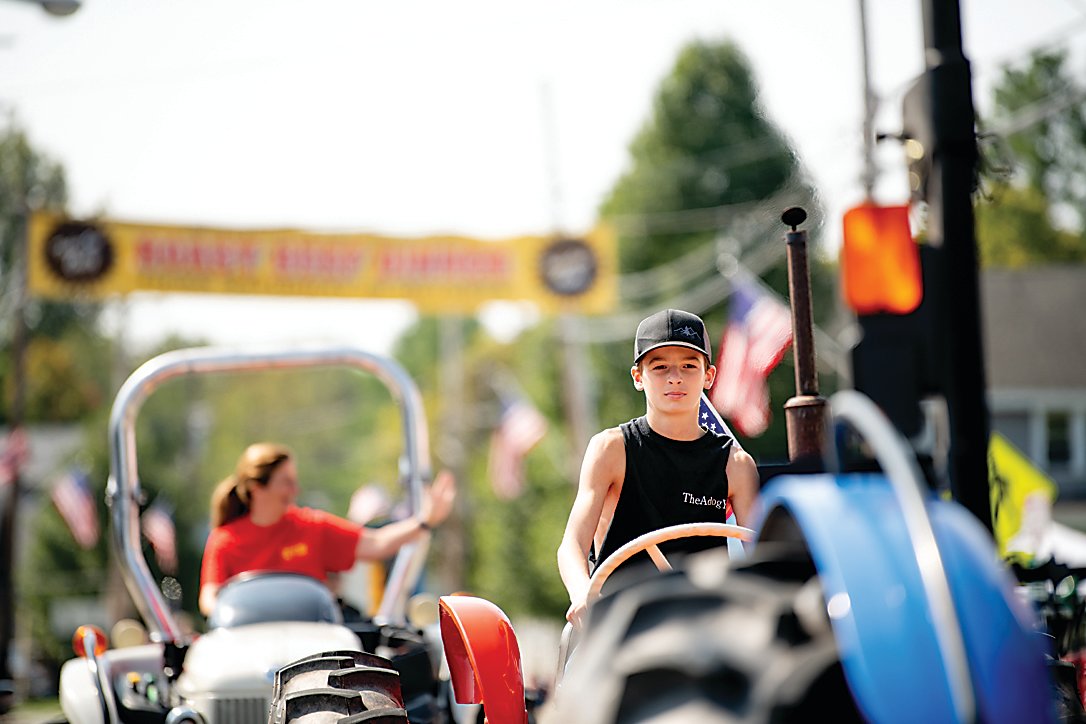 Dylan Scardefield keeps his eye on the road as he steers his tractor down the street.