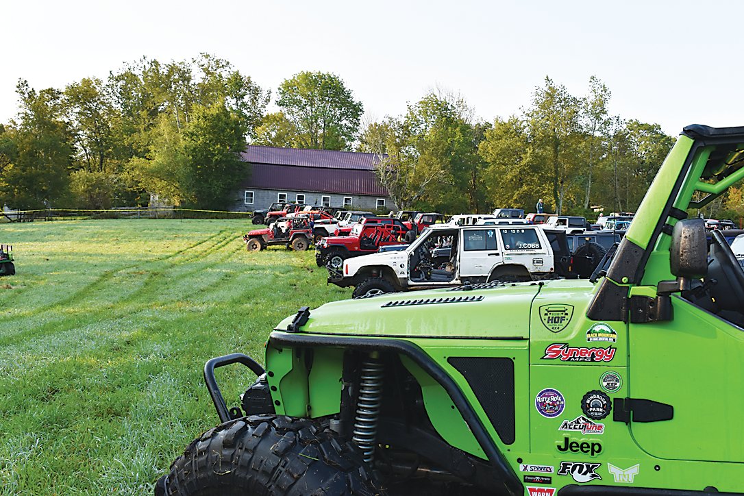 Hundreds of Jeeps staged in an open field, separated by the trails that they would be driving, awaiting the opening ceremony.