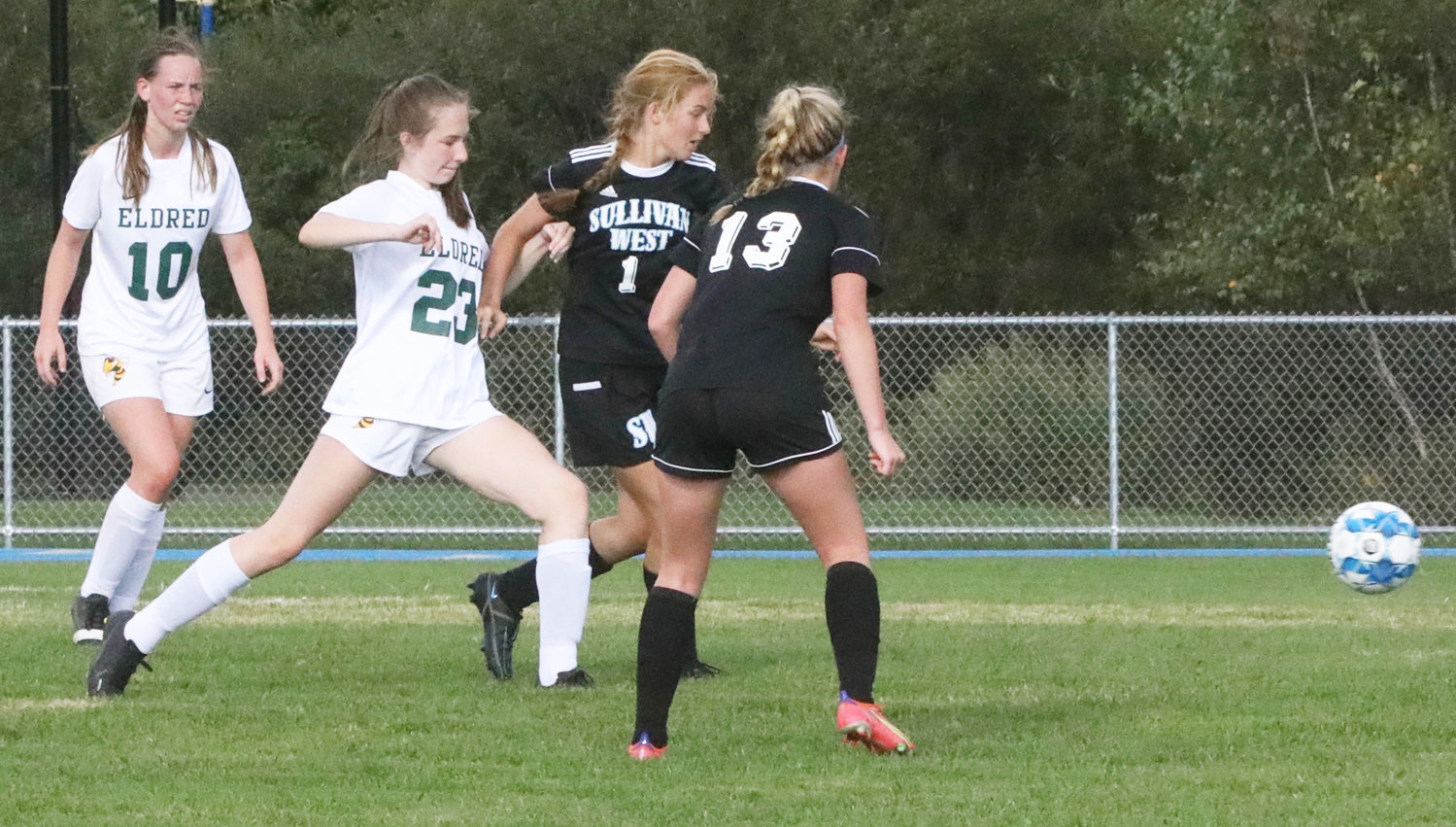 Eldred’s Tabitha Smith kicks the ball up the field between Sullivan West’s Nicole Reeves (1) and Sophie Flynn (13).