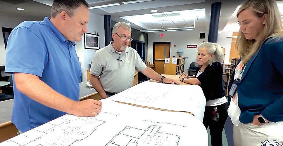 Looking over proposed project plans are Sullivan West Middle School Principal Scott Haberli (left), School Architect Tom Ritzenthaler from CSARCH, Superintendent of Schools Dr. Kathleen Bressler (front) and to her right, Assistant Superintendent of Administrative Services Lorraine Poston.