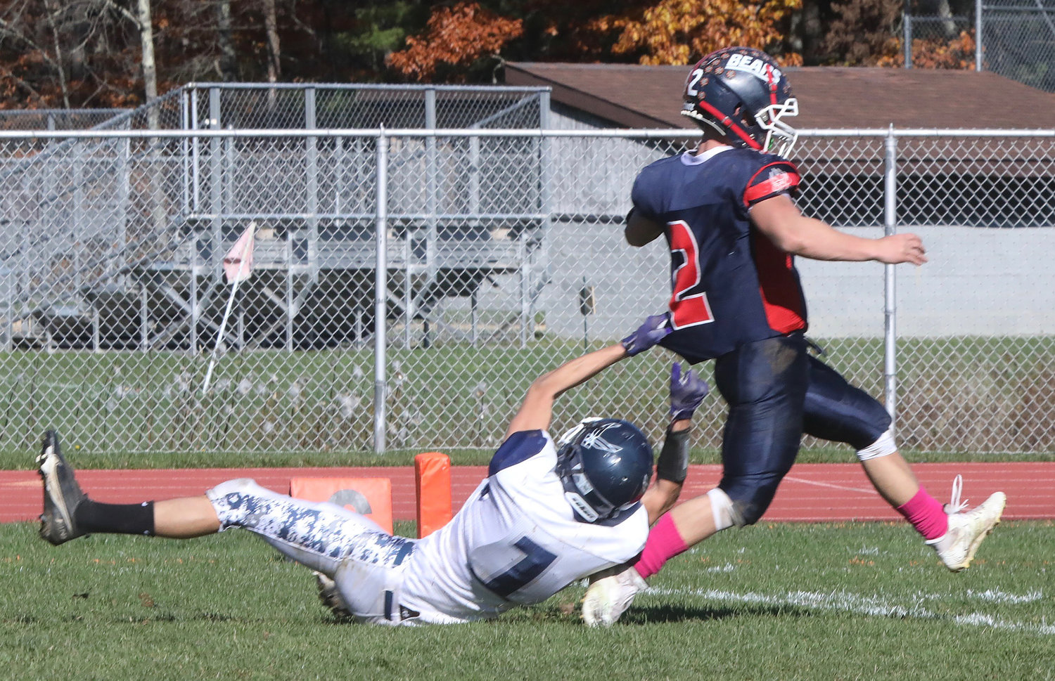 Tri-Valley quarterback Austin Hartman escapes the clutches of Pine Plains Giovanni Ramirez in one of his four TD runs. He also passed for another as the Bears rebounded from their loss against Sullivan West to beat Pine Plains and advance to the semifinals.