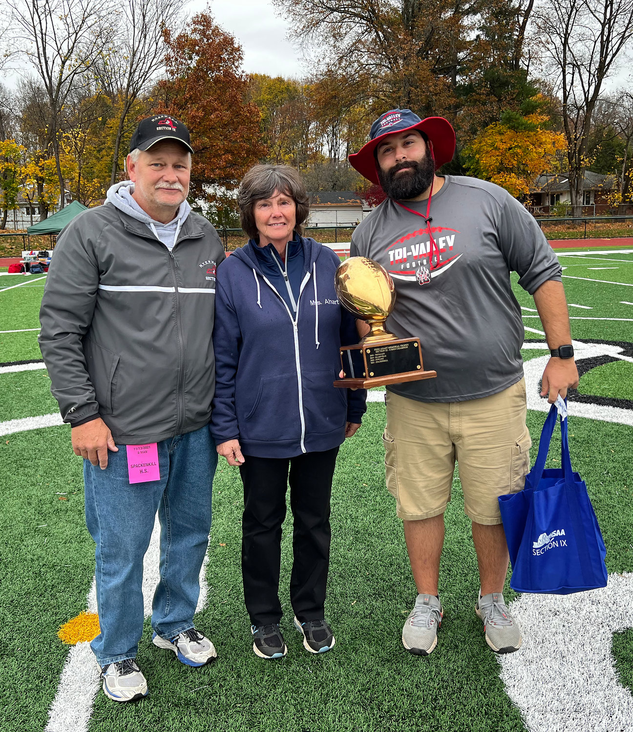 Tri-Valley head coach Kevin Crudele holds the Fred Ahart Eight-Man trophy presented by Becky Ahart and David Franskevicz.