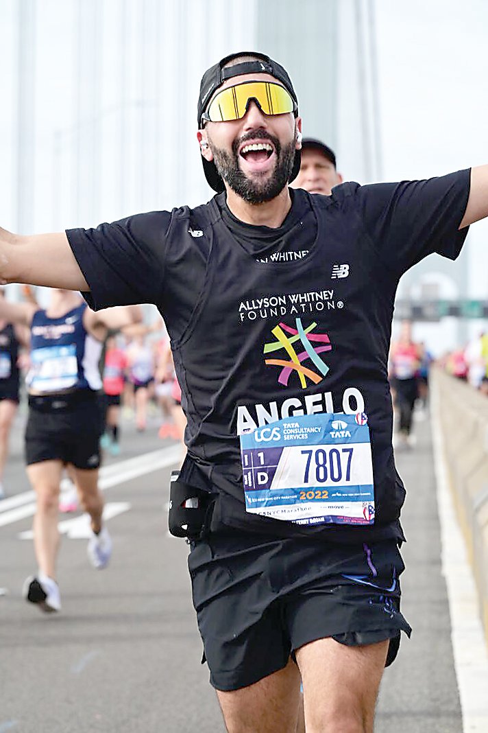 Angelo Cracchiolo is all smiles as he runs through New York City during the marathon.