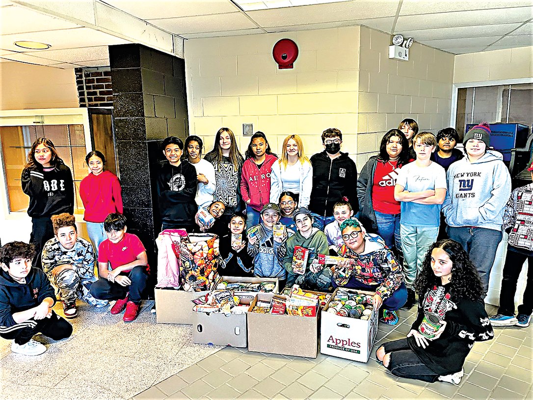 In the photo are many of the members and volunteers that supported the collection and distribution of food from the Benjamin Cosor Elementary School SGA, with just a few of the boxes of food collected.