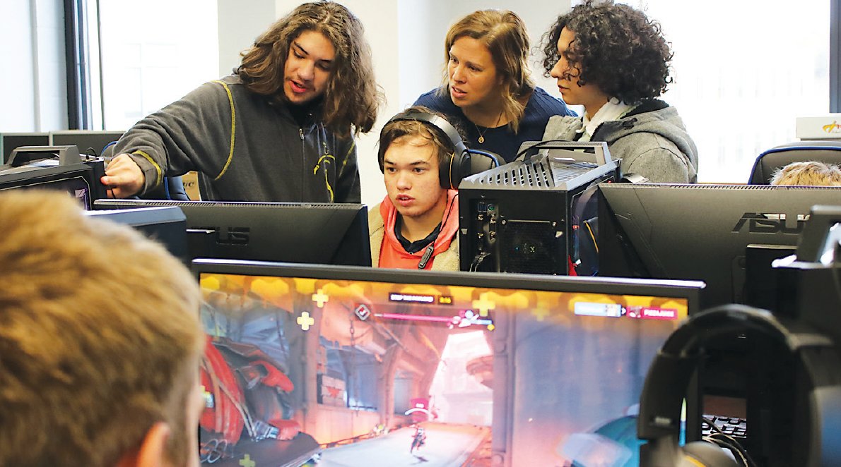 Teacher Krystal Herbert talks with student gamers just logging on and during a moment of strategy. See more from Sullivan West inside the latest School Scene!