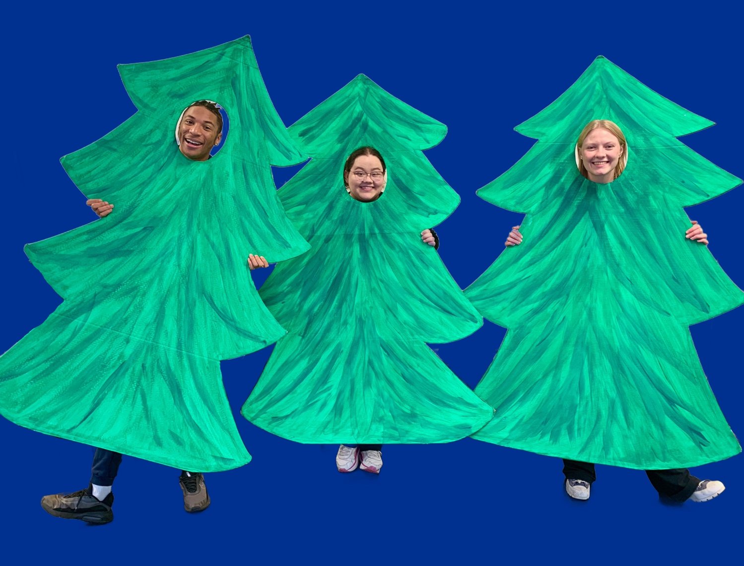 Members of the Paper Bag Players cast in tree costumes.