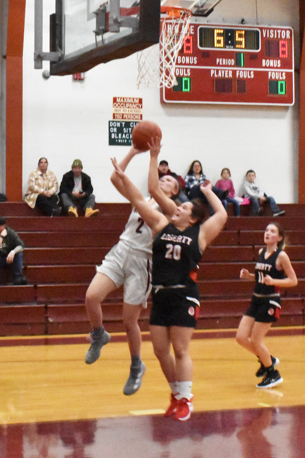 Mackenzie Carlson races down for a layup as time winds down in the first quarter. The shot gave Livingston Manor a 2-point lead.