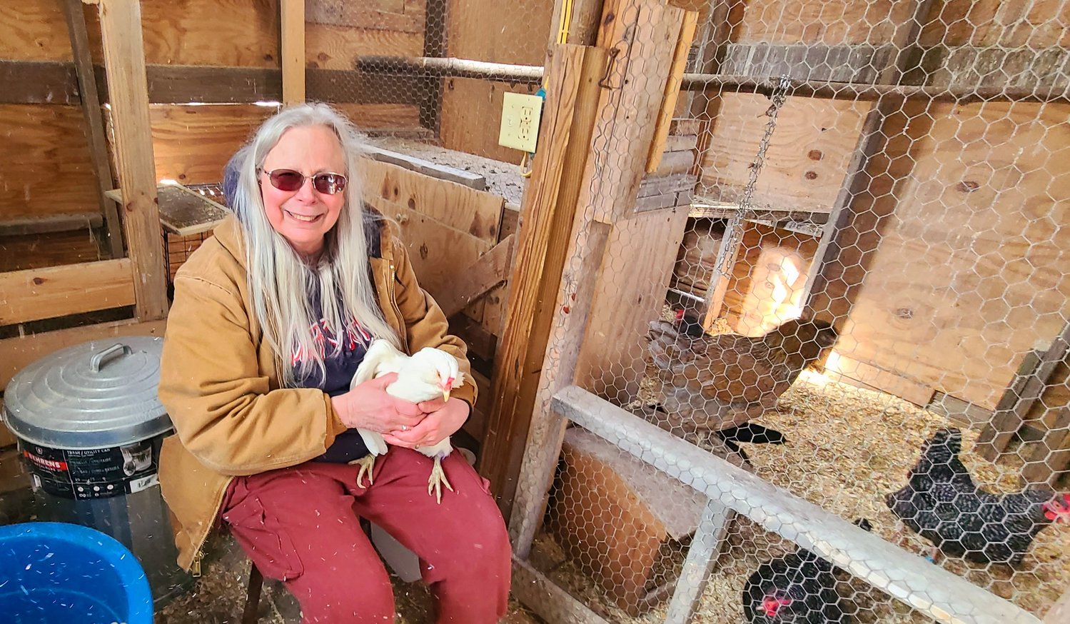 Chere Krist, the egg lady from Eldred, is holding Elsa, an Ameraucana that lays blue to light green eggs, and Chere has raised chickens since she was a small kid in Pennsylvania. Because of the bird flu she raises chickens from peeps that are one day old. Her flock of fourteen chickens are doing well and survived the extreme cold by getting a supplemental feeding of scrambled eggs with uncooked oatmeal.