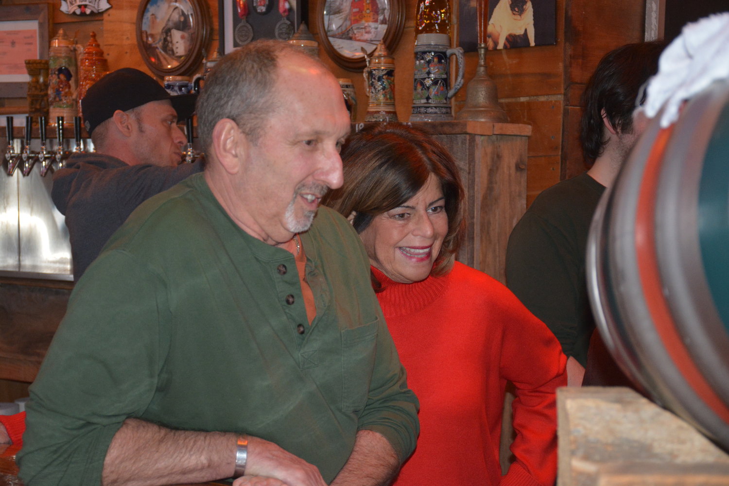 Liberty Town Supervisor Frank DeMayo, left, and Sullivan Catskills Visitors Association President/CEO Roberta Byron-Lockwood get a lesson from Castagna on how to tap the honorary keg at the bar, before DeMayo did the honors.