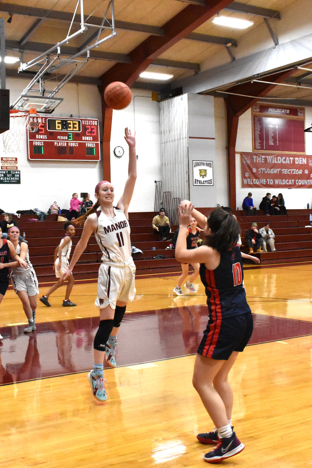 Tri-Valley’s Riley Kelly is unfazed by a leaping Livingston Manor defender as she releases a jump shot.