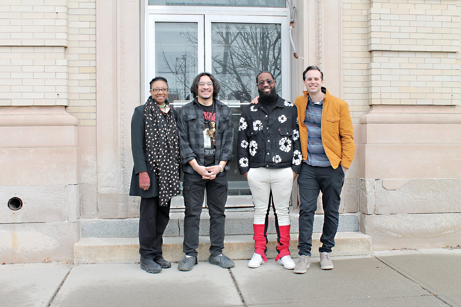 From left, Ellyane Hutchinson, Douglas Shindler, Michael Davis, and Tal Beery pose in front of the Historic Key Bank Building new home to the Black Library.