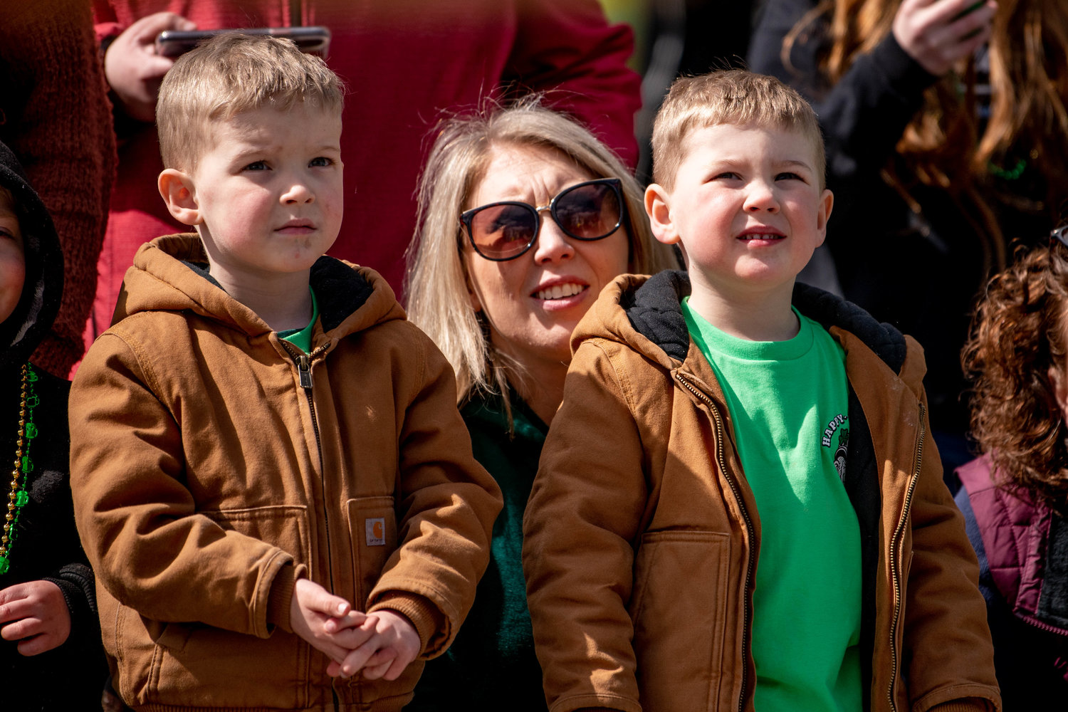Regina Murphy and her twin sons, Ryan and Aidan, watch the horses go by.
