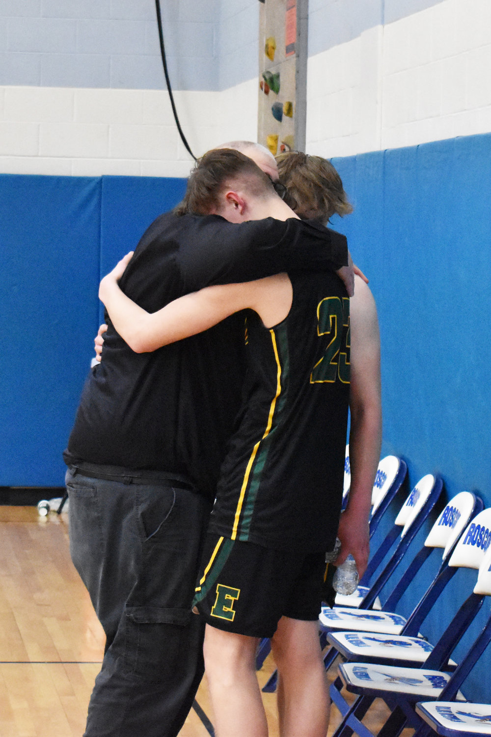 Coach Furler embraces his seniors, Frankie Whitmore and Sean Furler after their final high school season came to an end.
