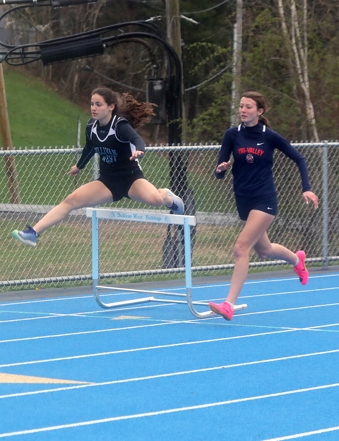 Sullivan West’s Brooke Nunnari edges out Tri-Valley’s Joyce Brooks in the 400-meter intermediate hurdles.