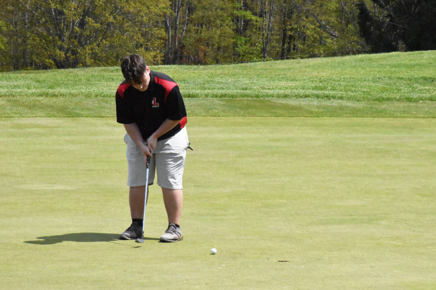 Liberty’s Larry Whipple putts on the 9th hole before moving on to finish the round.