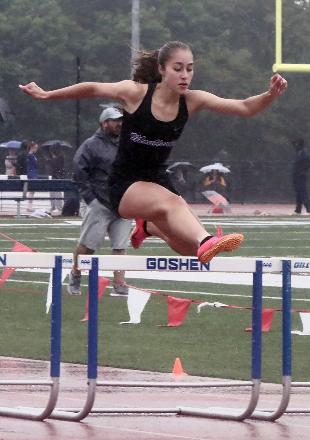 Monticello senior Taina DeJesus glides over the final barrier on her way to victory in the 400 hurdles. She took fifth in the 100 hurdles earlier.