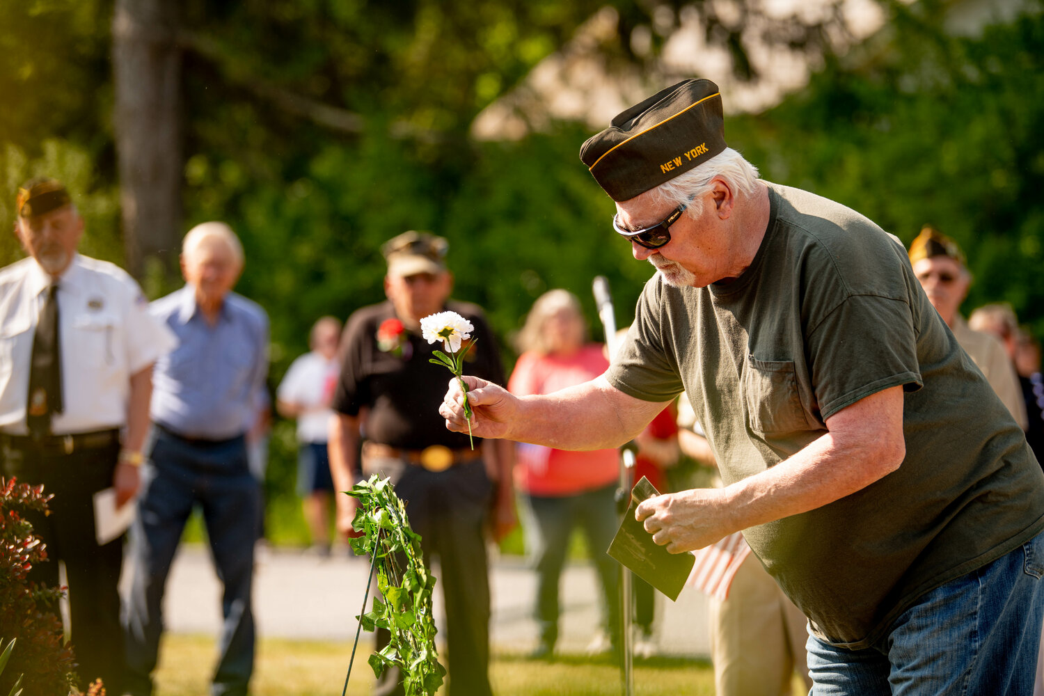 Vietnam veteran Mike Ristics of Damascus, PA, places a flower on the memorial wreath in memory of his fallen comrades.
