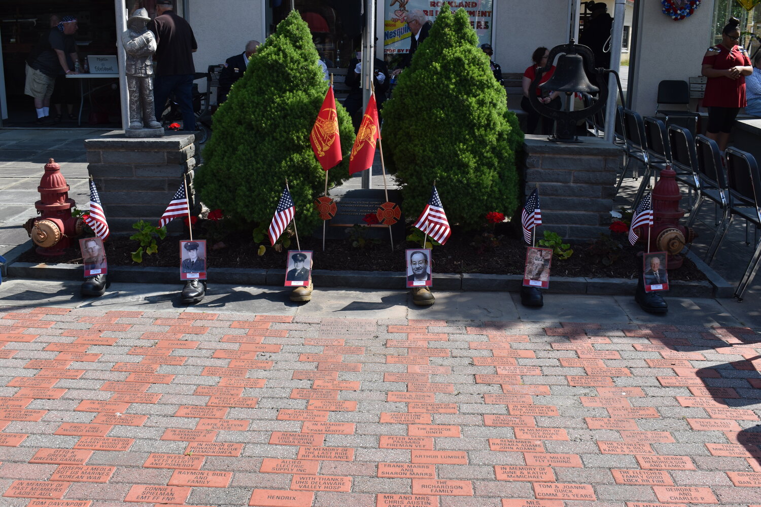 The Memorial Day committee set boots with flags and photos of deceased veterans along the parade route.