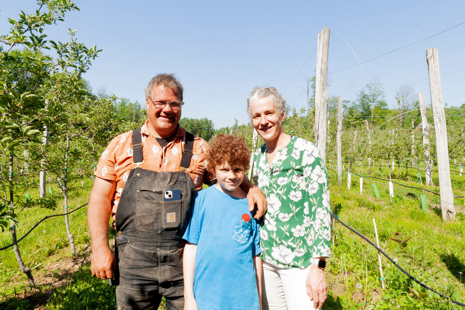 Brett Budde, with his wife and business partner Sara (right), along with their son, Rocket, operate Majestic Farm, an organic apple orchard and livestock farm in Mountaindale. They face the daunting task of recovering from the damage inflicted on their crop by a recent spring freeze.