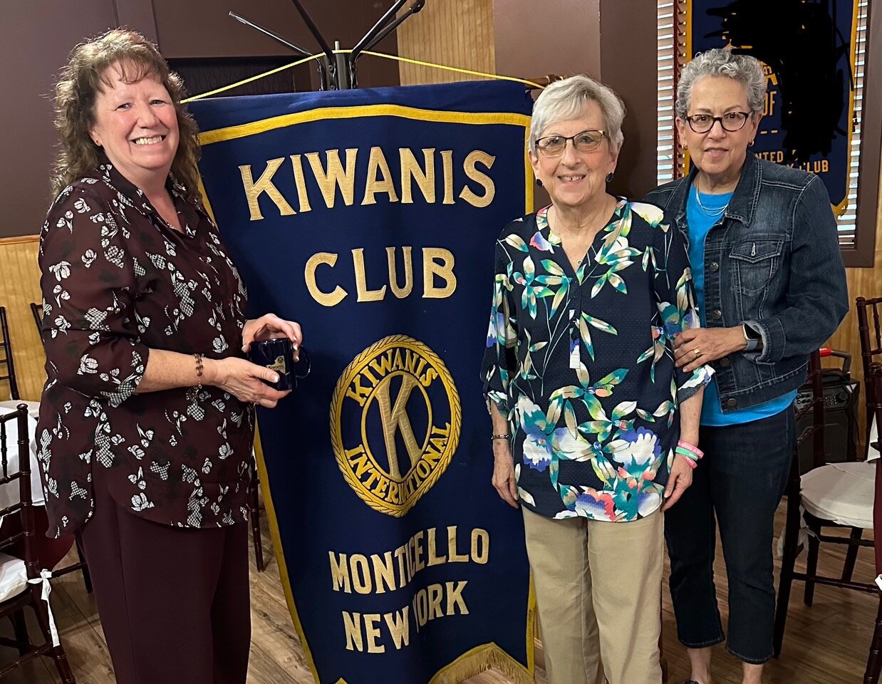 Debbie Worden holding a Kiwanis Cup with Publicity Chairperson Sheila Lashinsky and Vice  President Karen Ellsweig.
