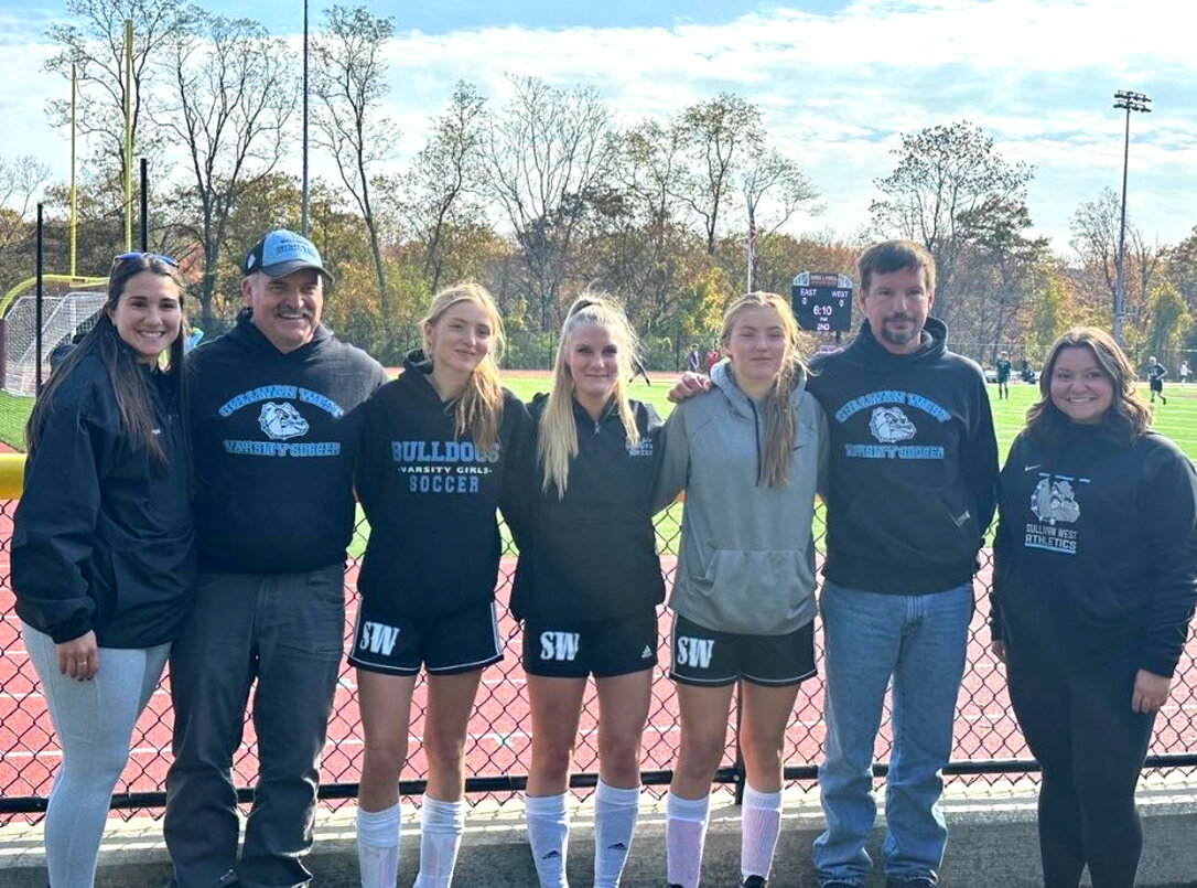 From left to right, Coach Samantha Cummings, Coach Anthony Durkin, Liz Reeves, Abby Parucki, Nicole Reeves, Coach Kurt Scheibe and Coach Megan Brockner.