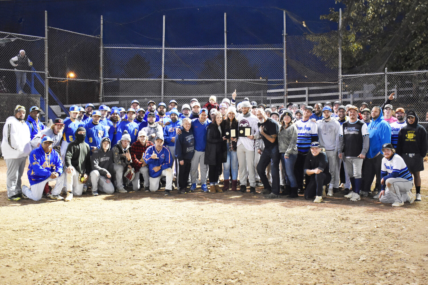 Players and tournament organizers gathered at home plate between games for a group photo and to present the Mills Family with a plaque in honor of Timmy Mills.