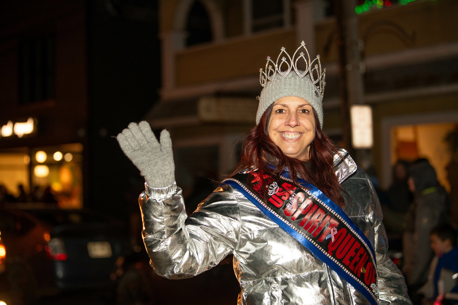 Marie Smith, USA Spirit Queen of Queens 2023-24, waves to the crowd as she walks down Main Street.