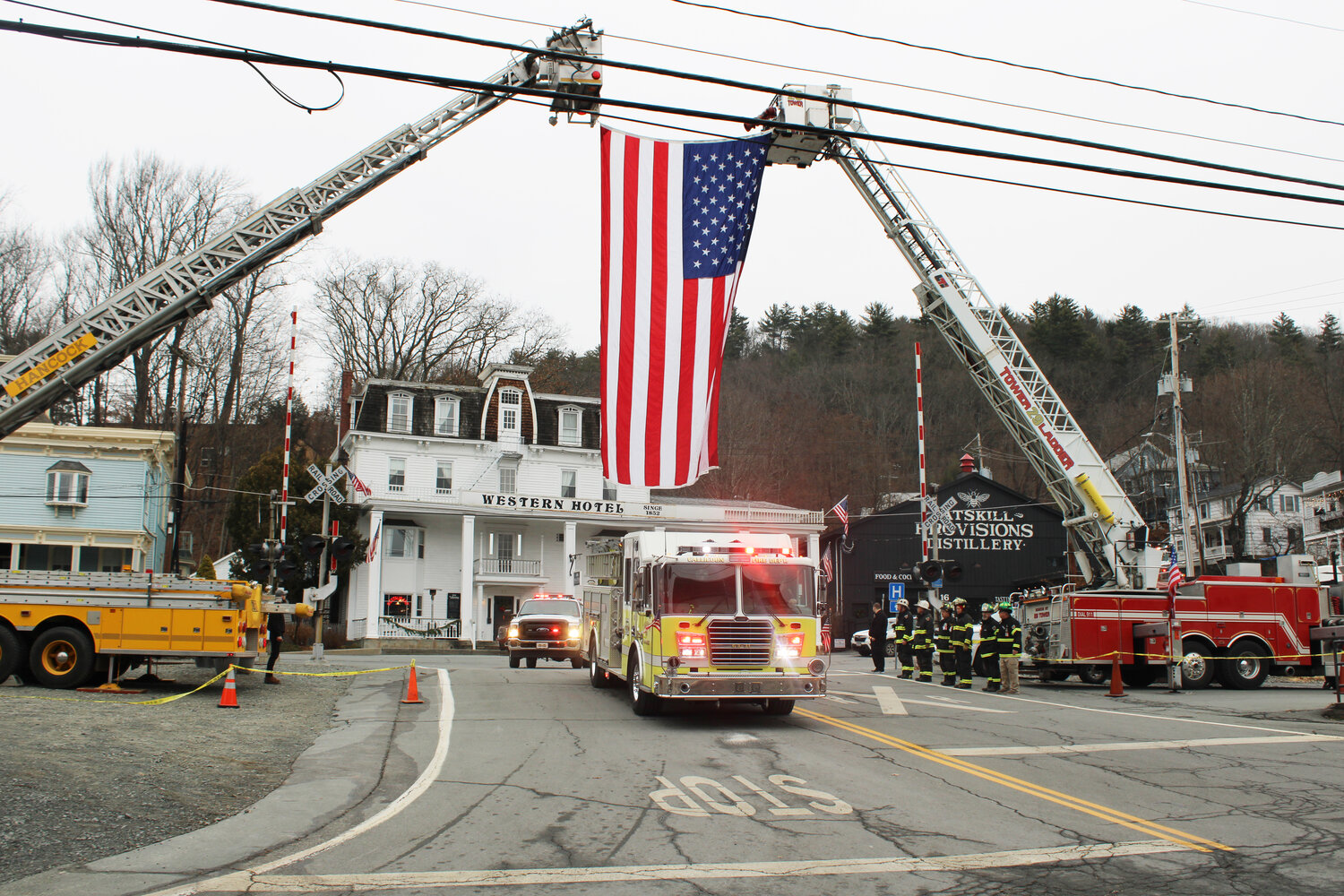 A Callicoon Fire Department truck drove under the U.S. flag held aloft by Roscoe-Rockland and Hancock Fire Departments. through Lower Main Street.