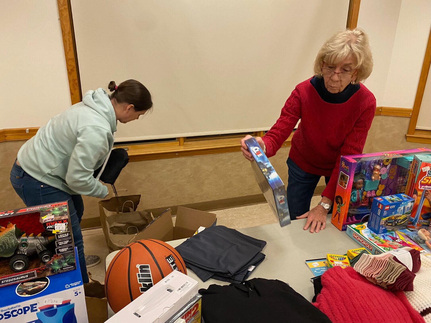 While the Monticello Fire Department Holiday Gift Drive is a yearly event, this season brought on an early start to the toy drive. Chris Kilgore, left, and Carol MacAdam meticulously organize and package the donated gifts intended for local children this holiday.