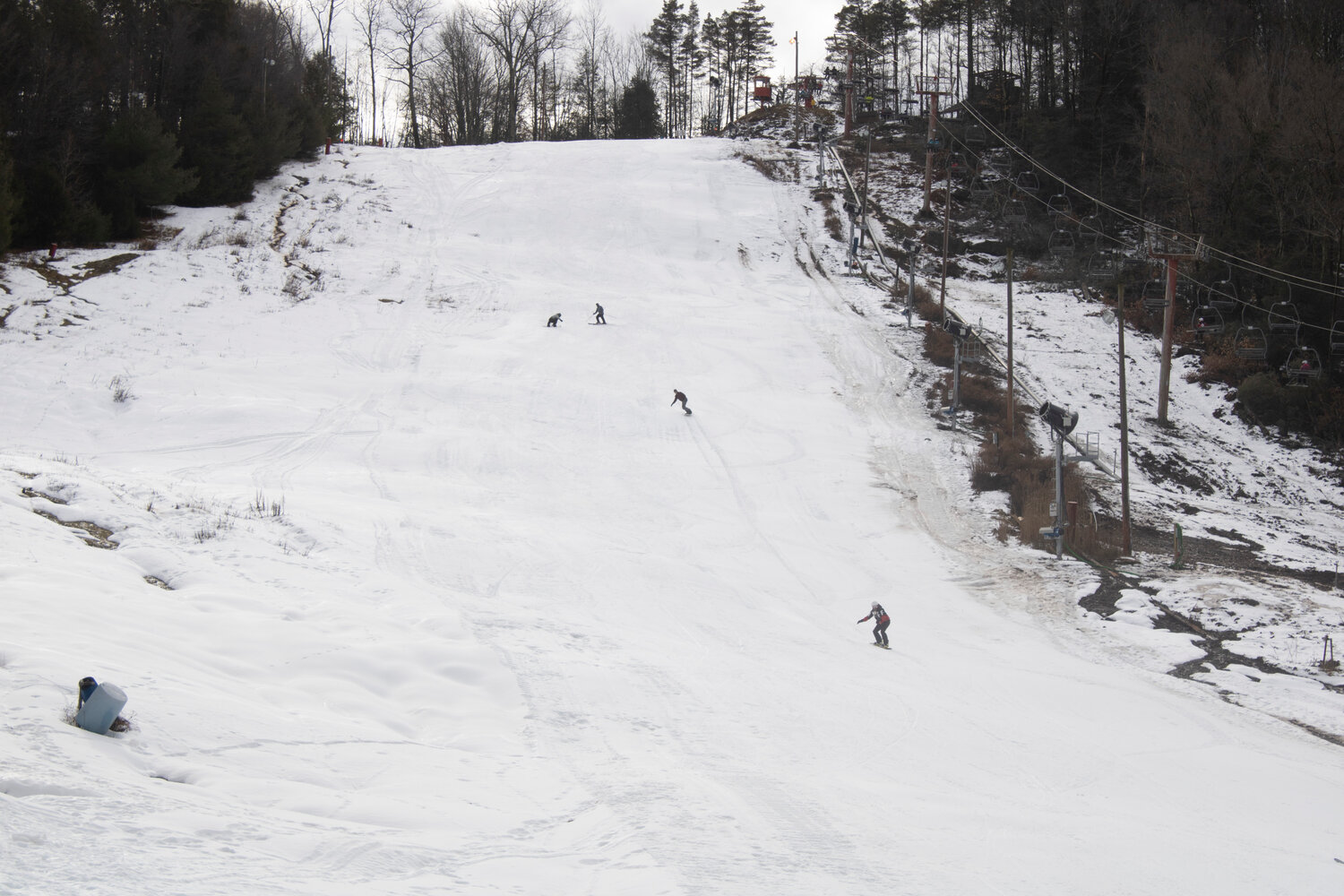 Skiers and snowboarders “shred the gnar” down Holiday’s black diamond trail, Roman Candle.