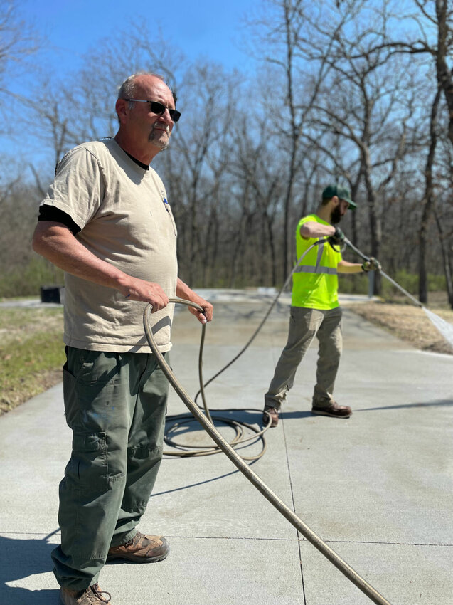 State workers Mike Thompson and Connor Ralston pressure wash the new cement pads at the Knob Noster State Park campgrounds Thursday, March 28. The newly improved campground will open April 15.


Photo by Chris Howell | Democrat