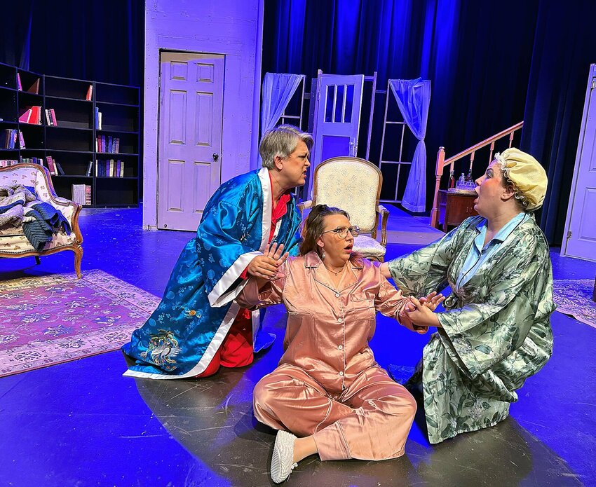 Lillian Seymour (Suzanne Peterson) and Kate Bixley (Jessica Jones) help Mystery author Crane Hammond (Amber Harshner) to her feet following a big stampede through her house during a dress rehearsal for 