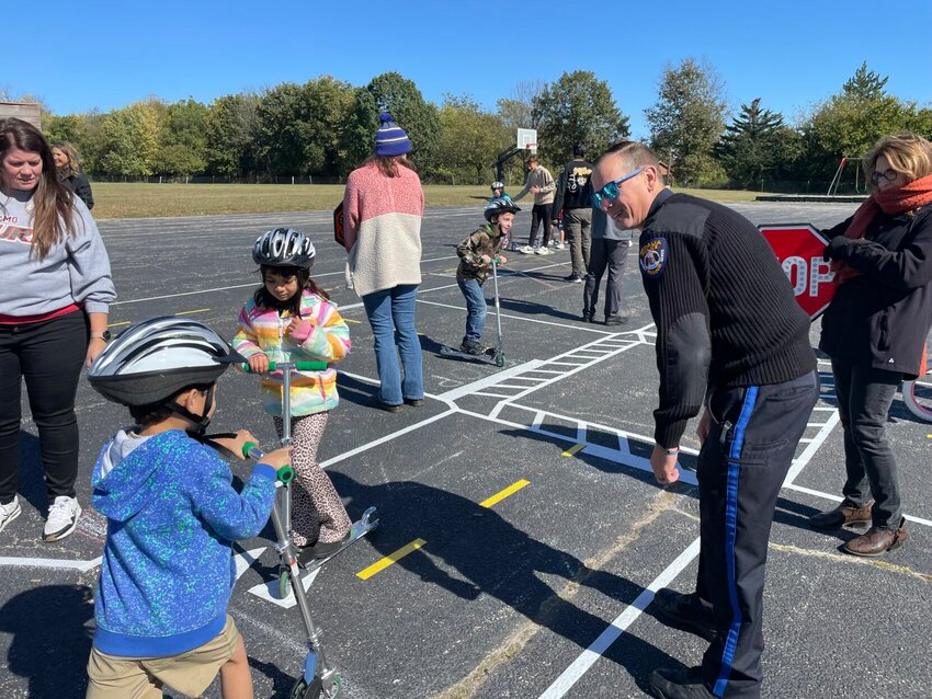 Corporal A.J. Silvey with the Sedalia Police Department's Traffic Division helps Parkview Elementary second graders learn the rules of the road at the MoDOT traffic garden Tuesday, Oct. 15. 


Photo by Chris Howell |Democrat