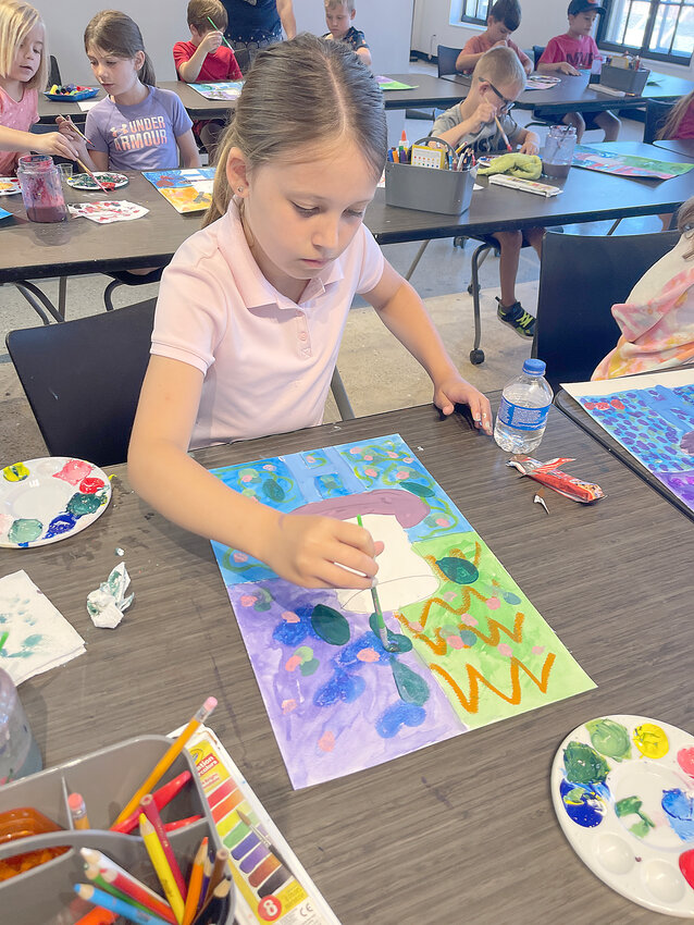 Isla Kempton, an elementary school student, works on a Matisse fishbowl painting during a 2024 summer art class at the Cooney Studio at the Hayden Liberty Center.