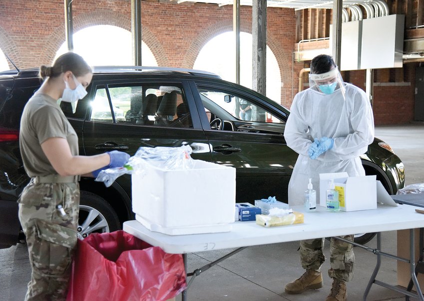 Members of the Missouri National Guard prepare to administer a free COVID-19 test to a person in June 2020 on the Missouri State Fairgrounds. Testing was done from 10 a.m. to 6 p.m. inside the Swine Pavilion.