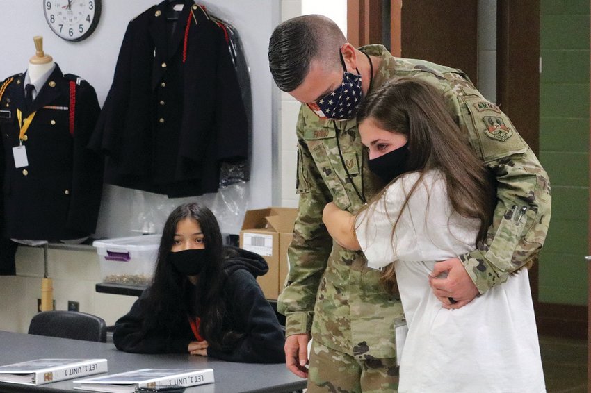 Freshman cadet Ellie Fiorino hugs her father, Air Force TSgt. Martin Fiorino, as he pays a surprise visit to her JROTC class on Friday, Nov. 6, at Smith-Cotton High School. Martin returned earlier in the day from a four-month deployment in Afghanistan.