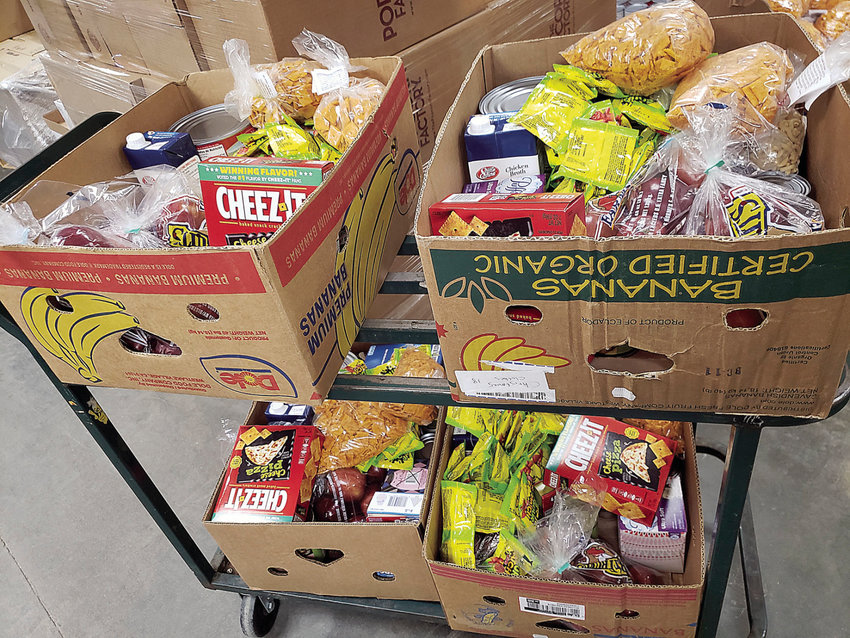 Boxes of food at Open Door Pantry wait to be placed into vehicles Monday, April 6.