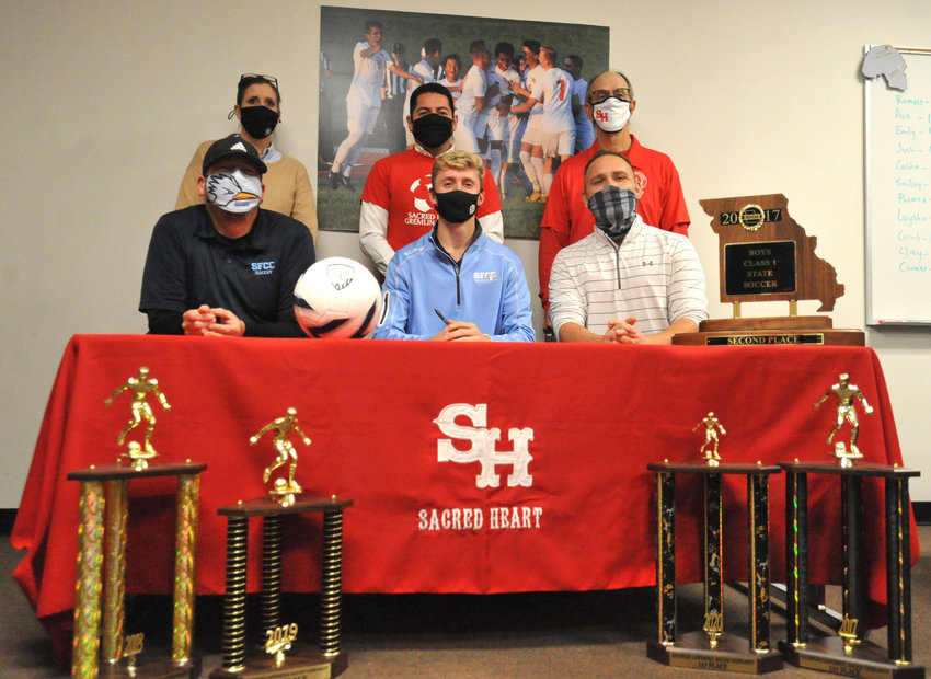 Gremlins senior Lucas Martin, front and center, poses for a photo Tuesday after signing a National Letter of Intent to play soccer at State Fair Community College during a signing event at Sacred Heart School. Lucas Martin is joined in the front row, from left, by State Fair Community College soccer head coach Jaime Beltran, and Sacred Heart soccer coach Sam Jones and, in the back row, Sacred Heart athletic director Amanda Blackburn, Gremlins assistant coaches Israel Baeza and Richard Bahner.