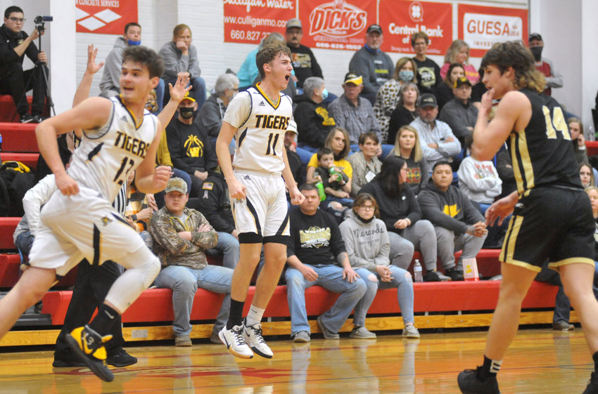Smithton senior Aaron Douglas celebrates a 3-point basket Saturday during a 59-49 victory over Windsor at the Kaysinger Conference Tournament at Sacred Heart School in Sedalia.