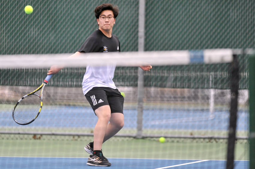 Smith-Cotton senior Michael Cho finishes a backhand swing Monday during a dual match with Knob Noster at Liberty Park in Sedalia.